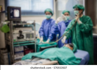 Blurred Of Doctor Insert  Bronchoscope To Patient