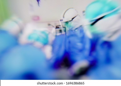 Blurred Doctor In Protective Clothing Taking Patient Suspected Of Being Infected By Virus Outbreak (Coronavirus COVID-19, Ebola, SARS) In Quarantine Room At Hospital