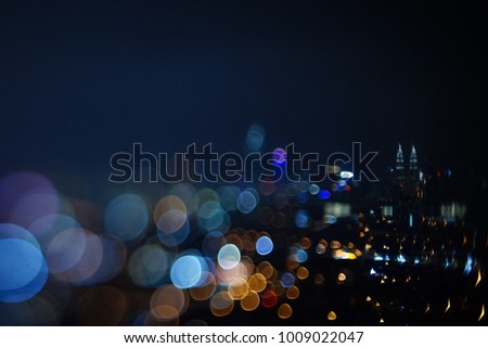 Blurred dramatic night view of city with abstract of LED, neon lights and beautiful bokeh.