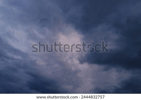 blurred, dramatic stormy dark clouds in evening sky, approaching thunderstorm. Concept on theme of Severe Weather, natural disasters, hurricane, typhoon, tornado, storm, natural basis for designer