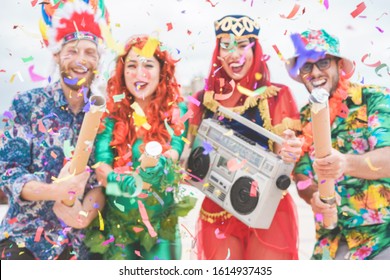 Blurred Dressed People Celebrating At Carnival Party Throwing Confetti - Young Friends Having Fun Together At Fest Event - Youth, Hangout, Festive And Happiness Concept - Defocused Image