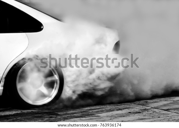 Blurred of drift car, Car wheel drifting and\
smoking on track.