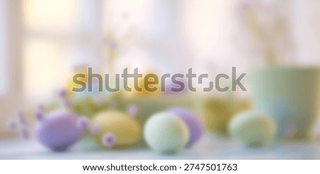 Blurred Easter themed background with pastel eggs and spring flowers. Soft seasonal holiday backdrop with copy space