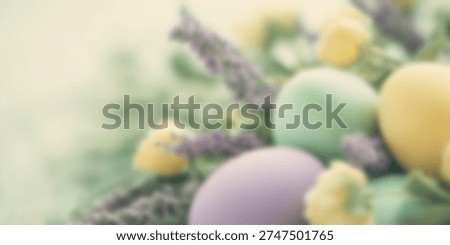 Blurred Easter themed background with pastel eggs and spring flowers. Soft seasonal holiday backdrop with copy space