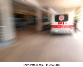 Blurred Of Emergency Medical Staff Team Transporting Patient To Hospital With Ambulance Into An Accident & Emergency Ward Of A Hospital. EMS.