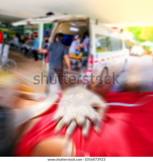 Blurred of emergency medical staff team\
transporting patient to hospital with ambulance into an Accident\
& Emergency ward of a hospital.Rescuer CPR, Training for safe\
life,Zoom effect.