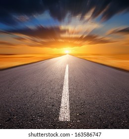 Blurred Empty Asphalt Road At Sunset