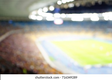 Blurred Empty Night Grand Soccer Arena In The Lights. Soccer Or Football Players. Abstract Sports Background With Bokeh.