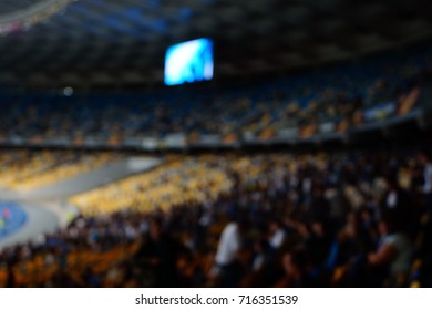 Blurred Empty Night Grand Soccer Arena In The Lights. Soccer Or Football Players. Abstract Sports Background With Bokeh.