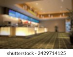 Blurred empty open space lobby cinema. Abstract light bokeh in cinema lobby interior background for design.