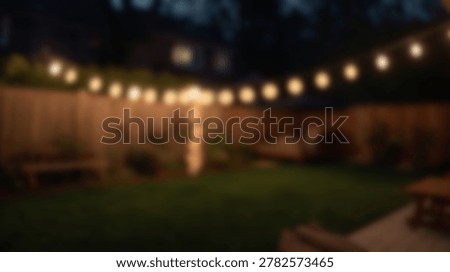 A blurred evening backyard scene featuring string lights, a wooden fence, and a grassy lawn. The warm glow of the lights creates a cozy atmosphere.