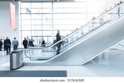 blurred Exhibition visitors at a escalator