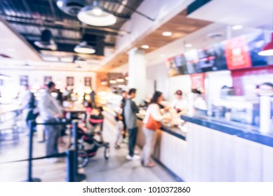 Blurred Family Members With Stroller Queuing Behind Stanchion Barriers Check-out Counter At Bakery In Texas, USA. Big Wall Mount Led Menu Board Digital Signage. Abstract Crowd Waiting. Vintage Tone