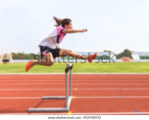 Blurred Female Jump Over Hurdle During Stock Photo Edit Now