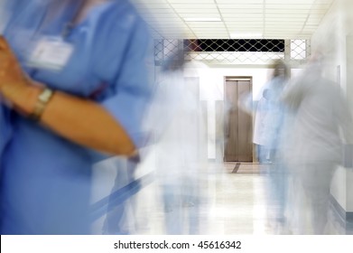 blurred figures of doctors and nurses in a hospital corridor. Corona virus, covid-19.