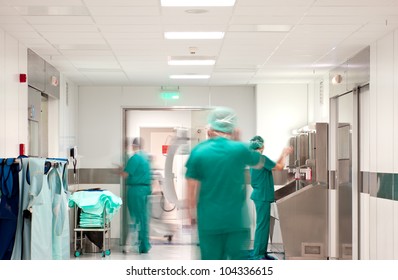 Blurred figures of people in medical uniforms in hospital preparing for operation. Corona virus, Covid-19.