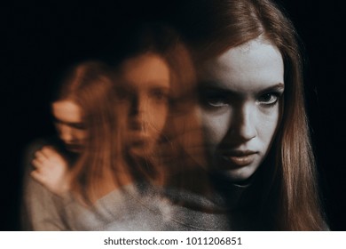 Blurred Figures Of A Red-haired Girl. Concept Of Mental Illness