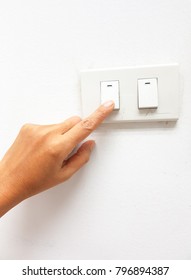 blurred finger woman is turning on/off on light switch isolated on white bavkground.