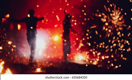 Blurred fireworks on beach at night fire-show performance