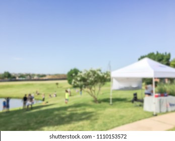 Blurred Fishing Community Event With Tent Setup At Neighborhood In Irving, Texas, USA. Family With Kids Fishing, Summer Leisure Activities, Outdoor Recreation Concept