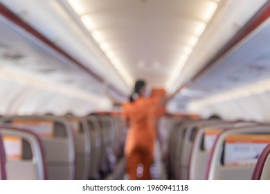 Blurred A Flight Attendant Cleaning The Luggage Container To Protect The Corona Virus.