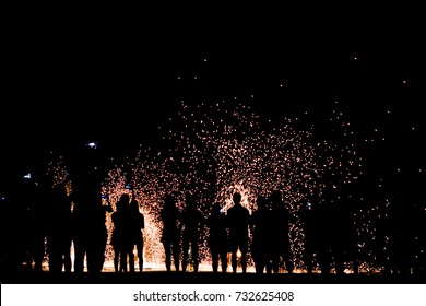 Blurred Focus Silhouette People Looking Show Of The Man Spin The Fire On Beach At Party Night