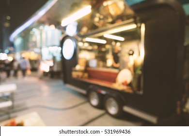 Blurred Of Food Trucks Parking.