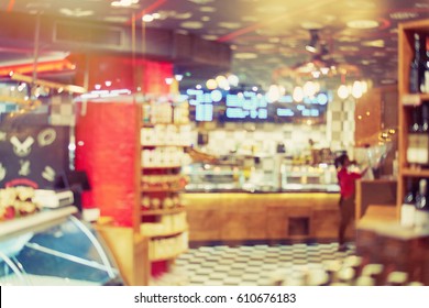 Blurred Front Store Window. Rack With Bottles Of Wine In A Butcher's Shop. Showcase Of The Grocery Store. The Worker Brings Order To The Working Day. Blurred Bokeh Basic Background For Design  