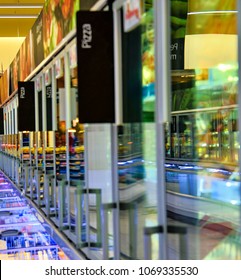 Blurred Frozen Food Section At Retail Store In Europe.  Freezer Full Assortment Of Frozen Pizza In Local Supermarket, Defocused Background.