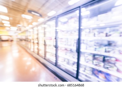 Blurred Frozen Food Section At Retail Store In America. Huge Glass Door Aisle With Variety Pack Of Ice Cream. Freezer Full Assortment Of Frozen Ice Cream In Local Supermarket, Defocused Background.