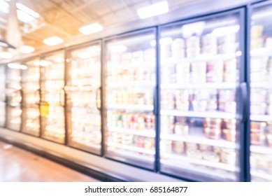 Blurred Frozen Food Section At Retail Store In America. Huge Glass Door Aisle With Variety Pack Of Ice Cream. Freezer Full Assortment Of Frozen Ice Cream In Local Supermarket, Defocused Background.