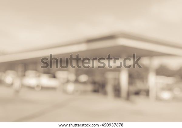 Blurred\
of gas station with car fill up fuel in daytime. Defocused, out of\
focus gas station in the morning. Abstract blur petrol station\
background with copy space. Vintage filter\
look.