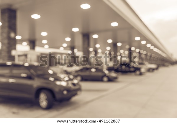 Blurred\
of gas station with car fill up fuel at twilight. Defocused, out of\
focus gas station in the morning. Abstract blur petrol station\
background with copy space. Vintage filter\
look.