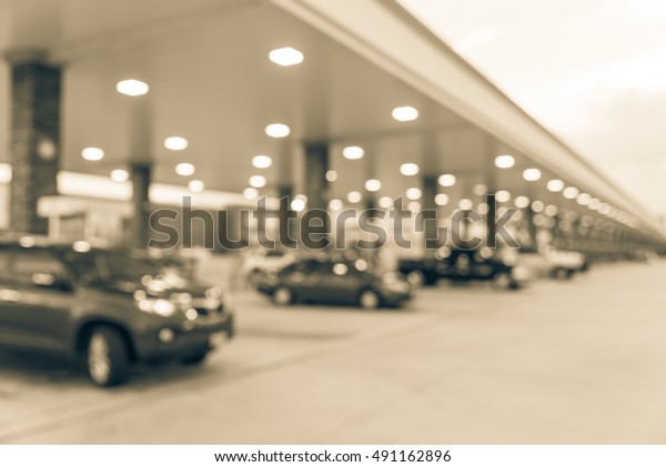 Blurred
of gas station with car fill up fuel at twilight. Defocused, out of
focus gas station in the morning. Abstract blur petrol station
background with copy space. Vintage filter
look.