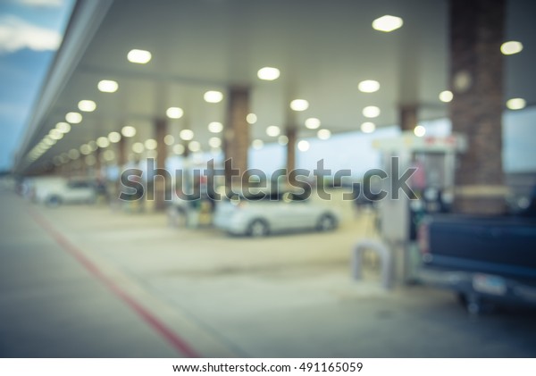 Blurred\
of gas station with car fill up fuel at twilight. Defocused, out of\
focus gas station in the morning. Abstract blur petrol station\
background with copy space. Vintage filter\
look.
