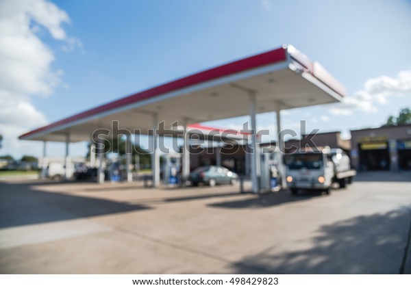 Blurred of gas station with\
car fill up fuel in daytime. Defocused, out of focus gas station in\
the morning. Abstract blur petrol station background with copy\
space