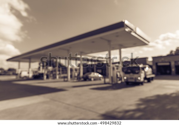 Blurred
of gas station with car fill up fuel in daytime. Defocused, out of
focus gas station in the morning. Abstract blur petrol station
background with copy space. Vintage filter
look.