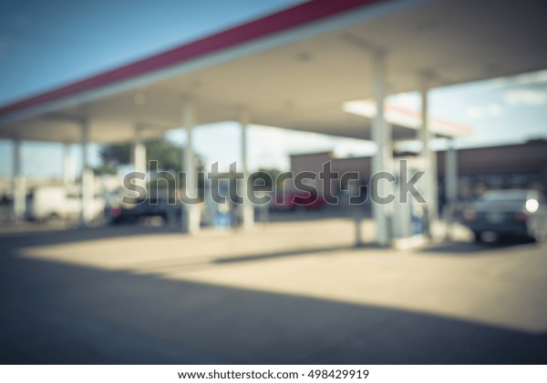 Blurred\
of gas station with car fill up fuel in daytime. Defocused, out of\
focus gas station in the morning. Abstract blur petrol station\
background with copy space. Vintage filter\
look.