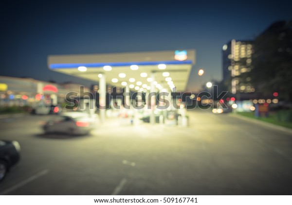 Blurred gas station in Houston, Texas, US at blue\
hour. Defocused, out of focus gas station and convenience store.\
Abstract blur petrol station, industrial background with copy\
space. Vintage filter.