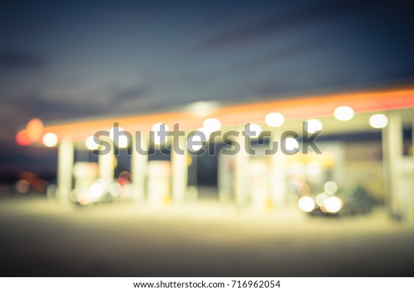 Blurred gas station in Houston, Texas, US at\
twilight. Defocused, out of focus gas station and convenience\
store. Abstract blur petrol station, industrial background with\
copy space. Vintage\
filter.