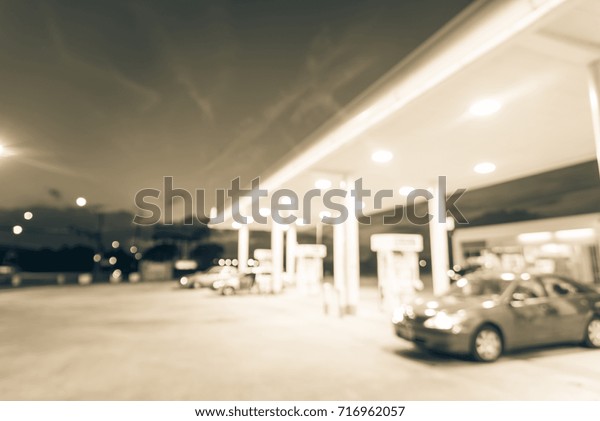 Blurred gas station in Houston, Texas, US at
twilight. Defocused, out of focus gas station and convenience
store. Abstract blur petrol station, industrial background with
copy space. Vintage
filter.