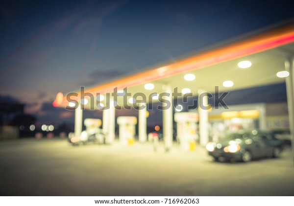 Blurred gas station in Houston, Texas, US at\
twilight. Defocused, out of focus gas station and convenience\
store. Abstract blur petrol station, industrial background with\
copy space. Vintage\
filter.