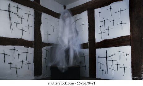 A Blurred Ghost Floating Above A Metal Box In A Corner Of An Old Timber Framed Building. Covered In Crosses.