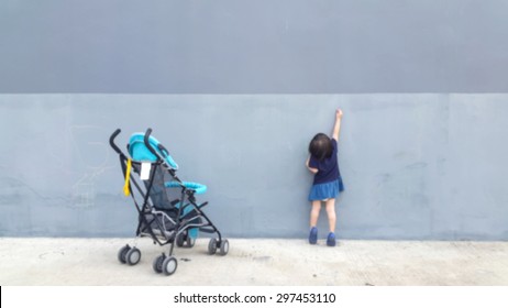 Blurred girls down from the cart. She is currently writing on the wall imagination. For blur background. bright tone
