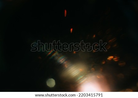 Blurred glow. Dark art background. Colored optical lens flare. Abstract design.