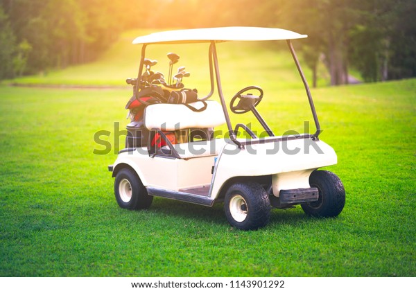 Blurred golf cart on\
fairway golf course