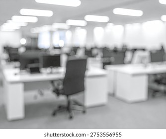 A blurred, grayscale image of an empty modern office space with rows of desks and chairs, illuminated by overhead lights.