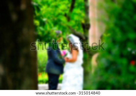 Blurred groom and bride with love in the nature outdoor park.