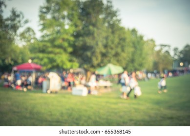 Blurred Group Of African American Friend, Family Members Enjoy Barbecue On Camping In Urban Park Downtown Houston, Texas, US. BBQ Grill Meat Skewers Smoke. Outdoor Party, Picnic Concept. Vintage Tone.