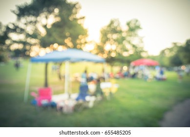 Blurred Group Of African American Friend, Family Members Enjoy Free Outdoor Music Festival, Open-air Concert Held In Public Park At Houston. Audience Sits On The Chairs, Grass, Open Tent. Vintage Tone